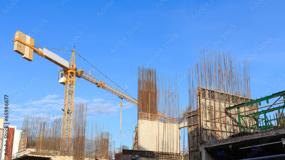 Building crane and construction site under blue sky Building crane and construction site under blue sky