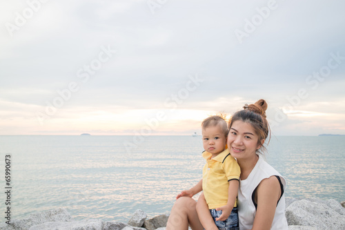 Asian boy pose on the beach with his mother © punsayaporn