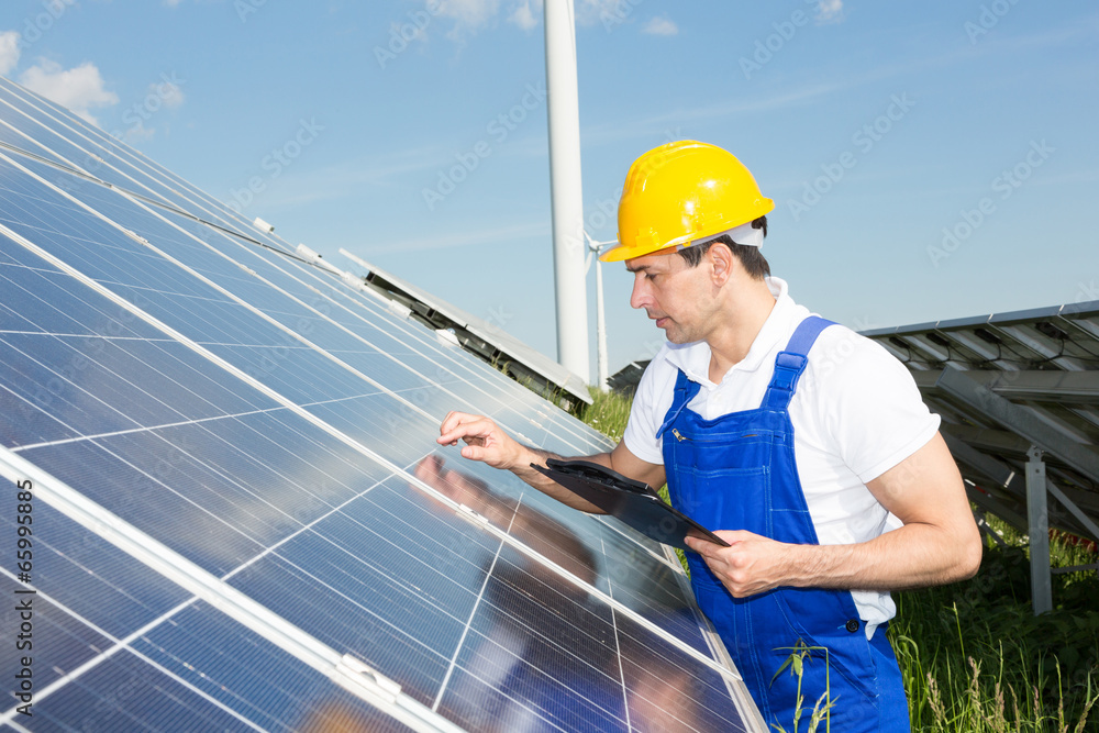 Engineer inspects solar panels at energy park Engineer inspects solar panels at energy park