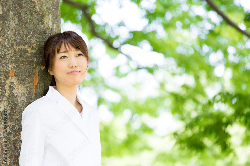 young asian doctor relaxing on green background young asian doctor relaxing on green background