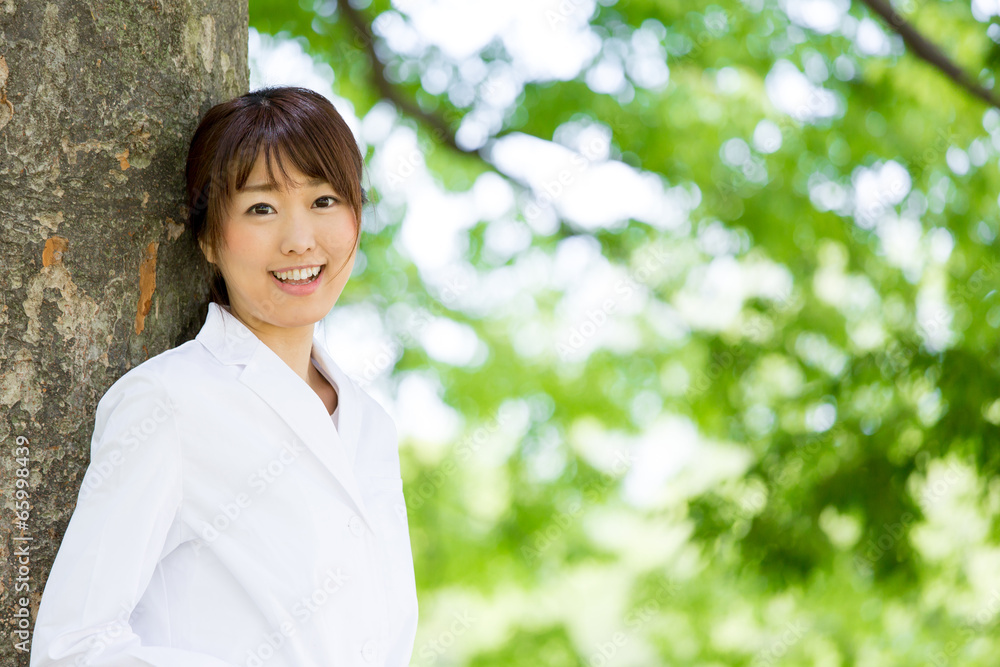 young asian doctor relaxing on green background young asian doctor relaxing on green background