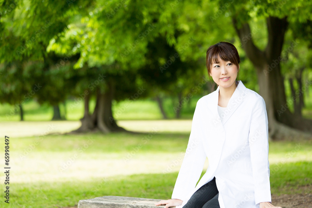 young asian doctor relaxing on green background young asian doctor relaxing on green background
