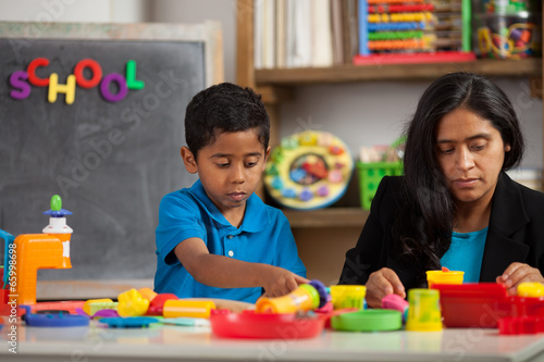 Hispanic Mom with Child in Home School Setting Working on Crafts