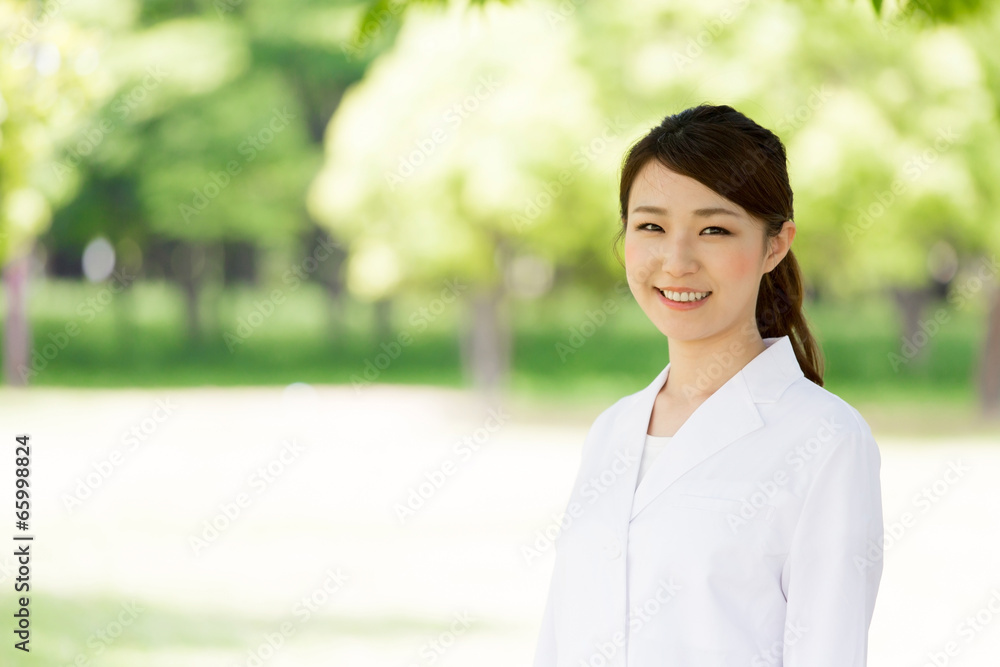 young asian doctor relaxing on green background young asian doctor relaxing on green background