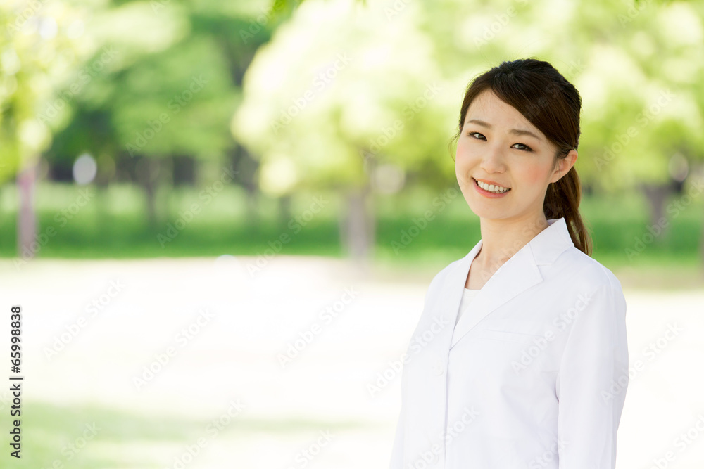 young asian doctor relaxing on green background young asian doctor relaxing on green background
