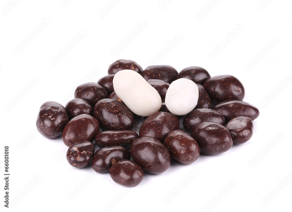 Dark brown dragee in chocolate cover.