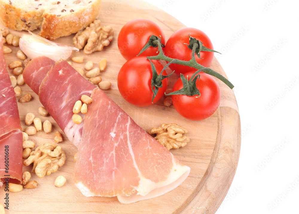 Composition of prosciutto on wooden platter. Composition of prosciutto on wooden platter.