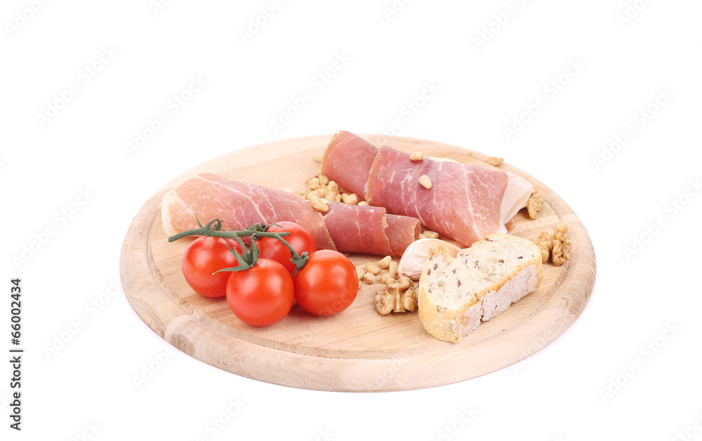 Prosciutto and tomatoes with bread on platter. Prosciutto and tomatoes with bread on platter.