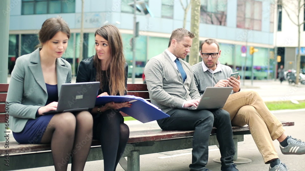 Busy business people working on bench in the city Busy business people working on bench in the city