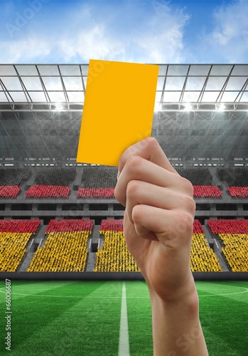 Composite image of hand holding up yellow card © WavebreakMediaMicro