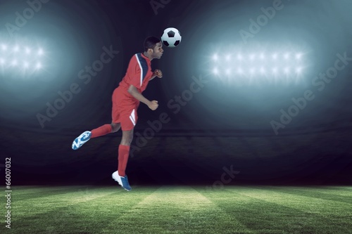 Composite image of football player in red jumping © WavebreakMediaMicro