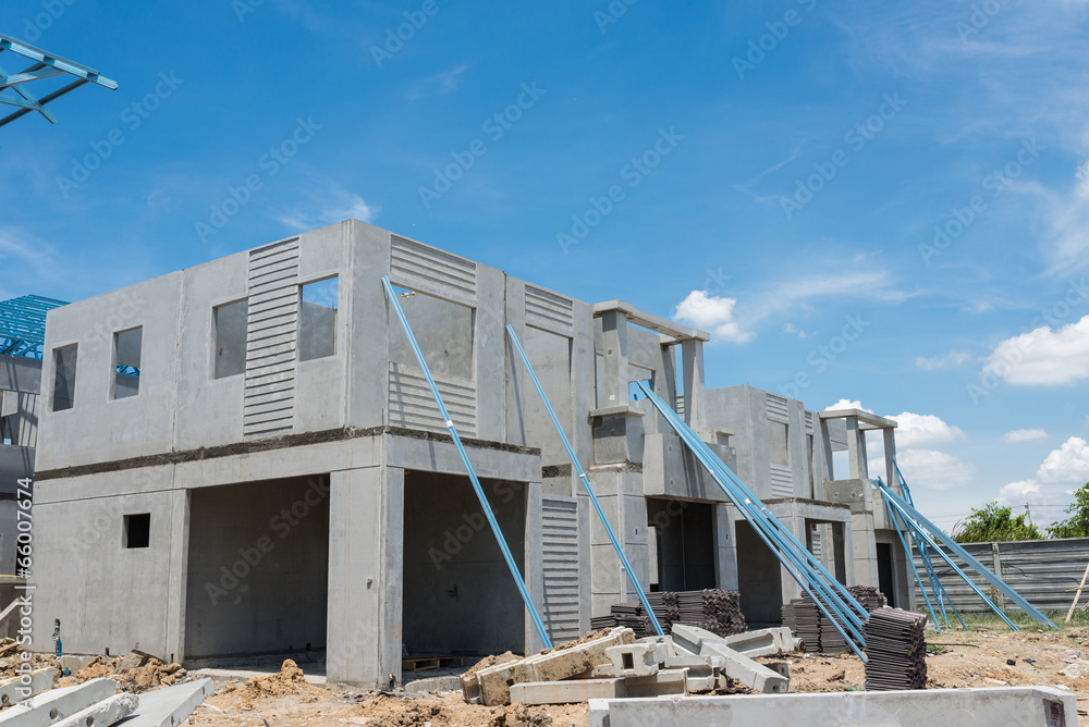 New home under construction using steel frames against cloudy sk New home under construction using steel frames against cloudy sk