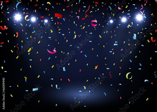 colorful confetti on black background with spotlight