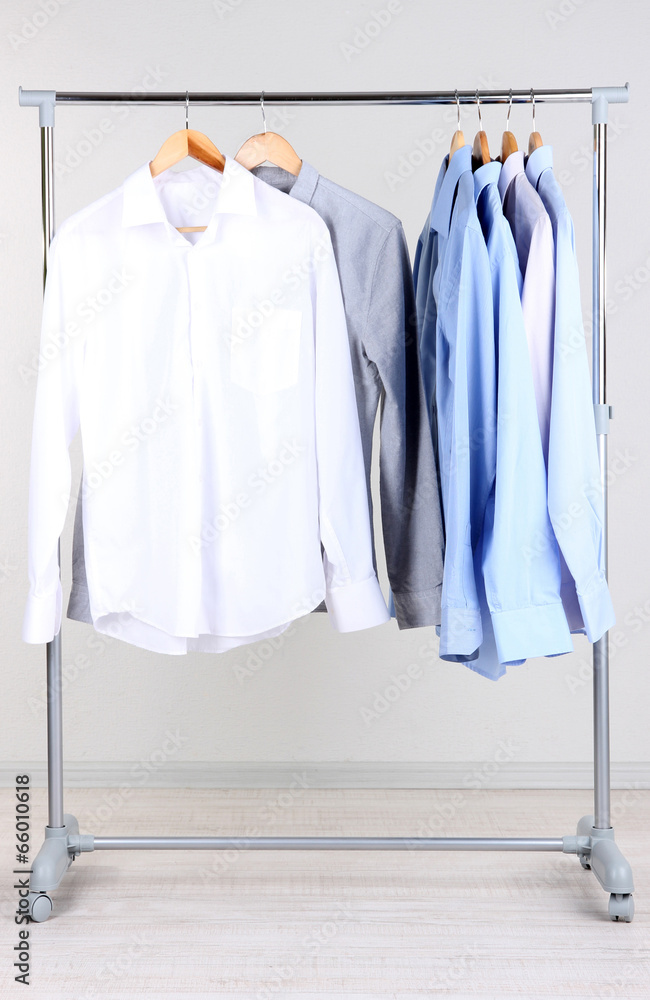 Office male clothes on hangers, on gray background Office male clothes on hangers, on gray background