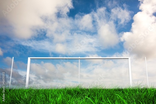 Football goal under blue cloudy sky