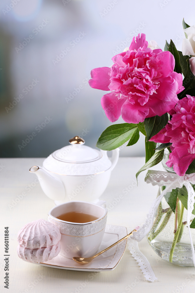 Composition of beautiful peonies in vase, tea in cup and Composition of beautiful peonies in vase, tea in cup and