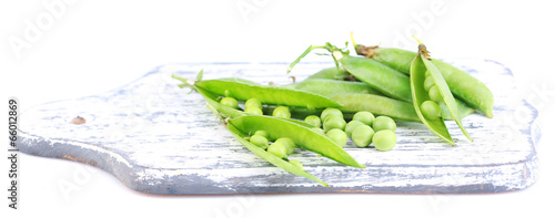 Wallpaper Mural Fresh green peas on wooden board isolated on white background Torontodigital.ca