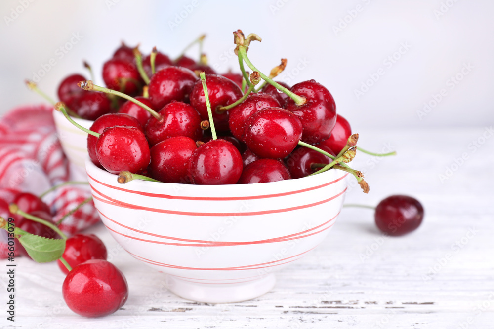 Ripe sweet cherries in bowl on wooden table Ripe sweet cherries in bowl on wooden table