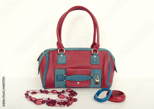 Red and blue purse with matching necklace and bracelets.
