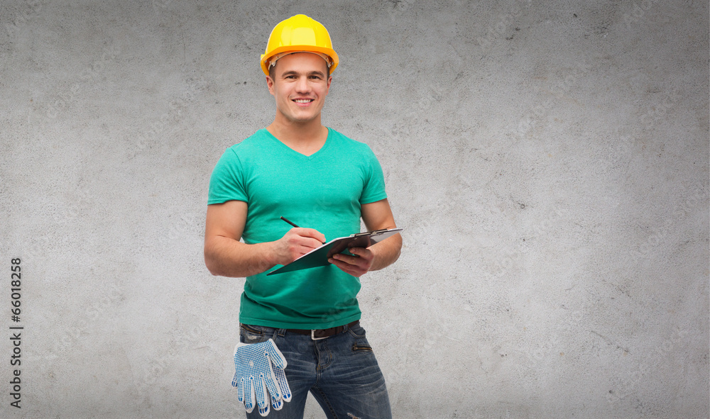 smiling man in helmet with clipboard smiling man in helmet with clipboard