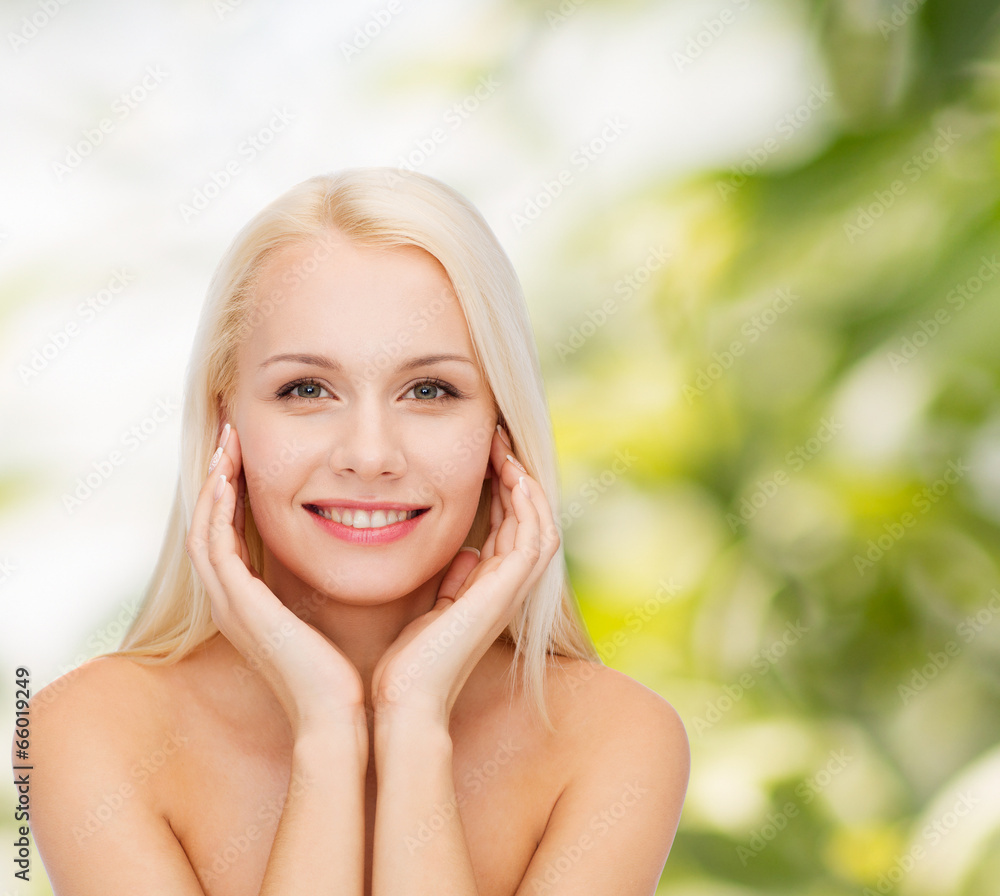 face of beautiful woman touching her face skin
