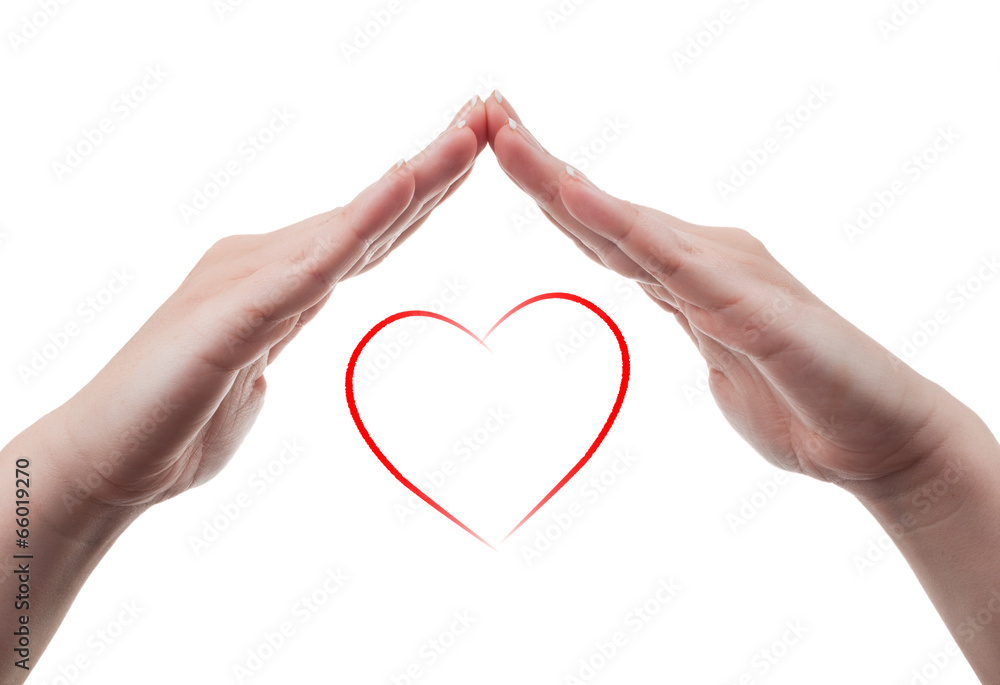 Fototapeta premium Female hands protecting a heart shape on white background
