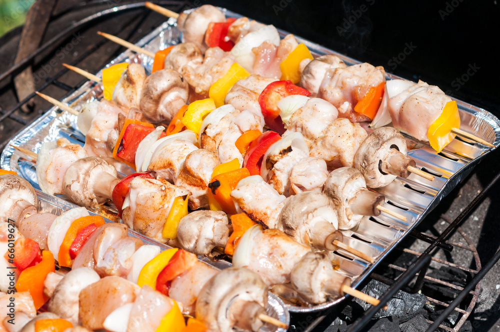 preparation for the barbecue - raw skewers on a tray