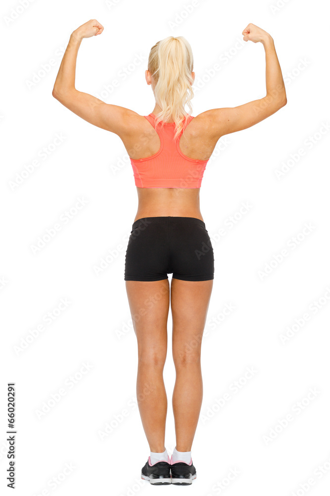 sporty woman from the back flexing her biceps sporty woman from the back flexing her biceps