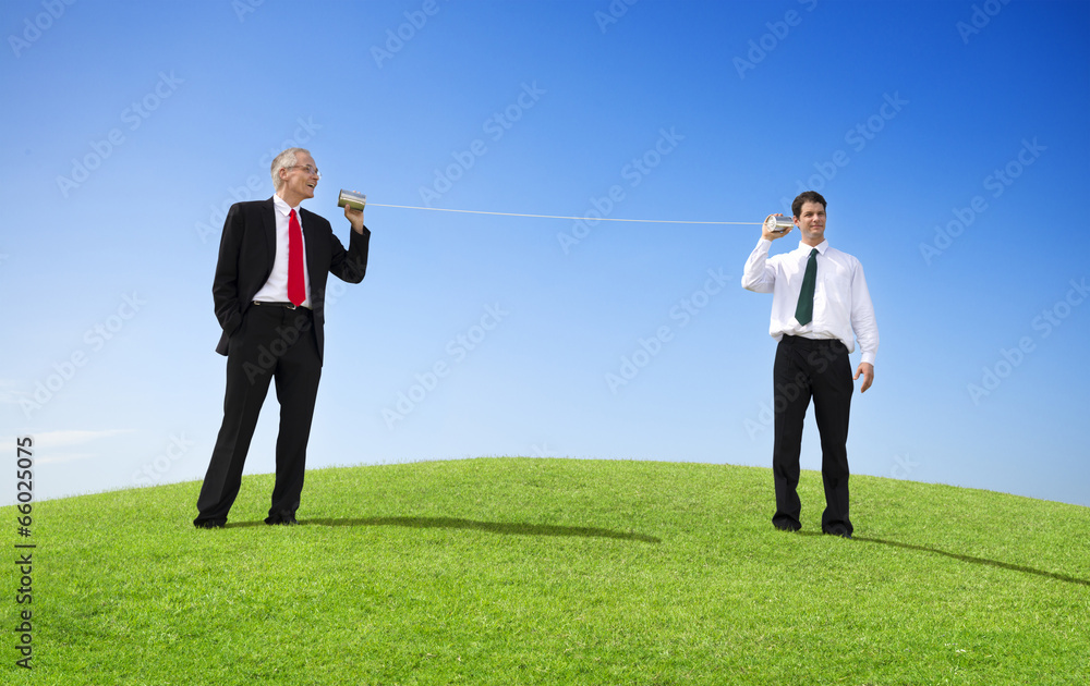 Business Men Outdoors Talking Through Tin Can Phone Business Men Outdoors Talking Through Tin Can Phone