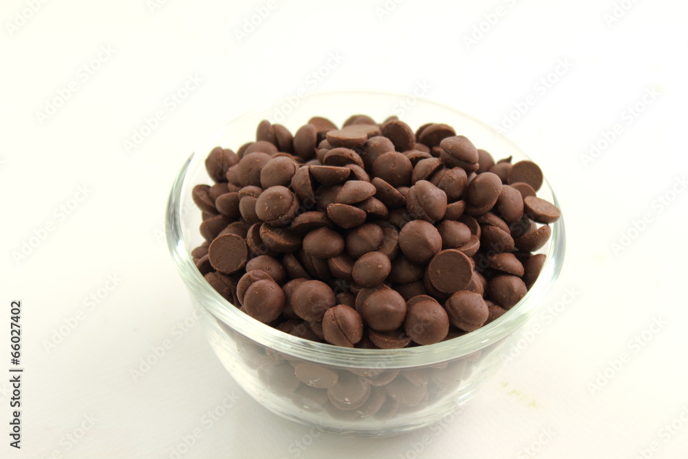 chocolate chip in glass cup on white background chocolate chip in glass cup on white background