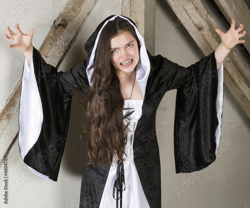 young woman dressed as a witch photo