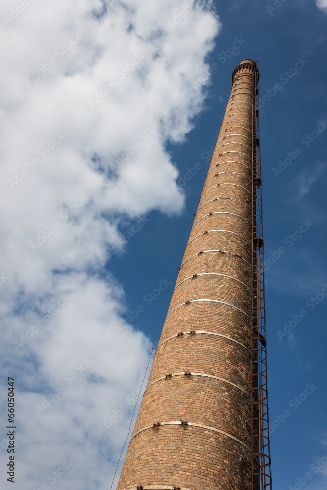 Old smokestack against blue sky