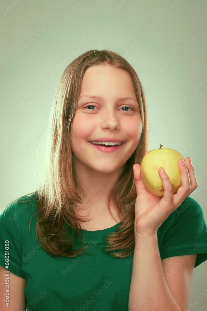 Portrait of a cheerful teen girl with an apple Portrait of a cheerful teen girl with an apple
