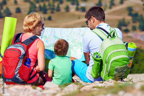 happy family in mountains discussing the route