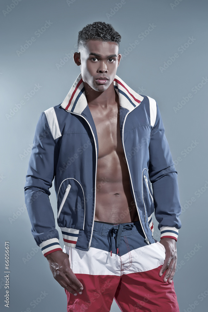 Obraz premium Black african fitness man wearing blue jacket and striped shorts