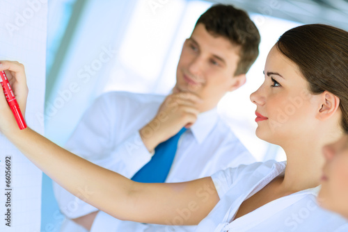 businessmen are meeting near the flipchart