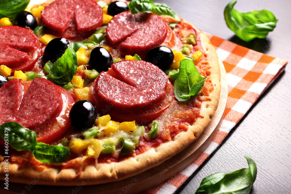 Pizza with tomato, salami, olives and basil Pizza with tomato, salami, olives and basil