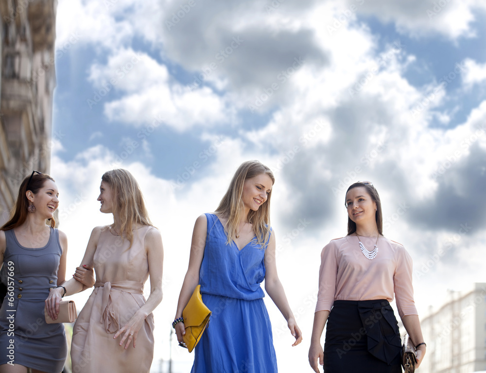 Four beautiful fashion girls walking on the street Four beautiful fashion girls walking on the street