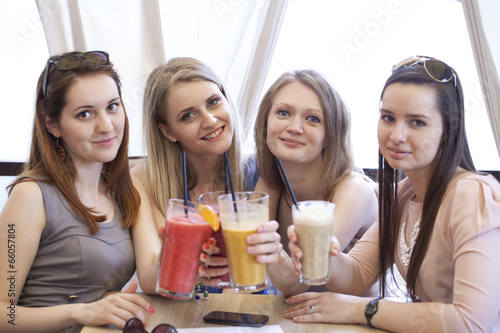 Four young girls have a rest in a summer cafe