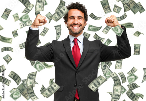 Happy man enjoying the rain of money photo