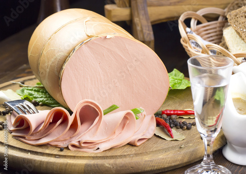 sausages on a wooden plate with vegetables in a restaurant photo