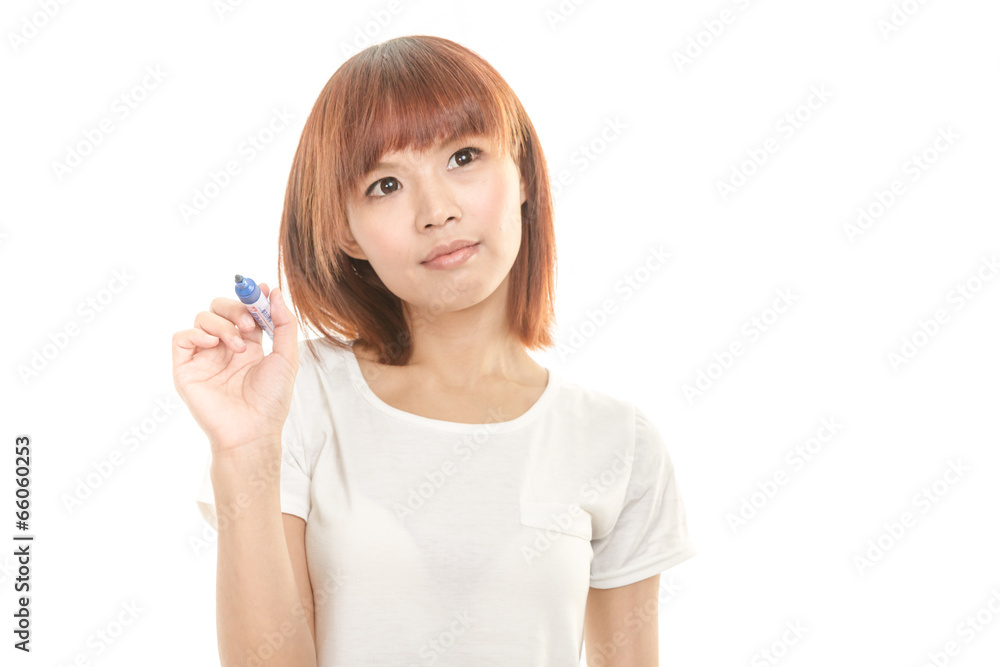Asian woman writing with blue marker on imaginary board Asian woman writing with blue marker on imaginary board