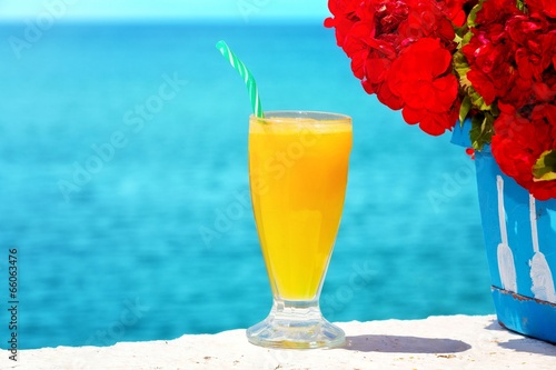 Refreshing looking orange juice,at the sea.