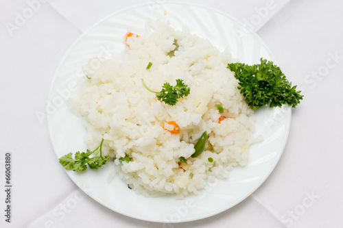 Plate full of rice on white