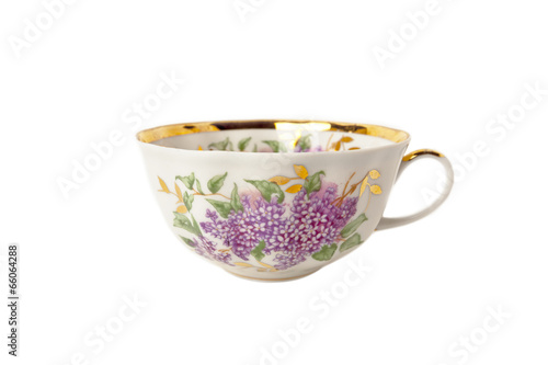 Porcelain teacup with floral ornament on white
