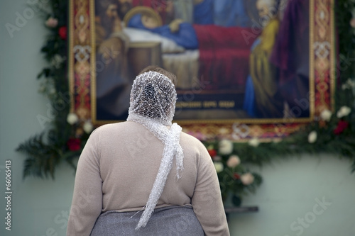 Woman  looking at the icon of the Dormition of the Virgin.