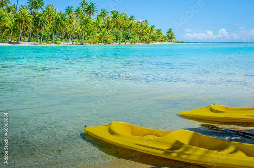 Empty kayaks on the shore of a tropical island