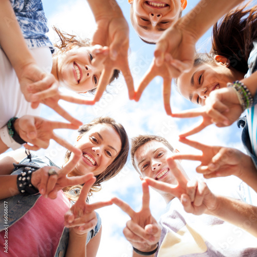 group of teenagers showing finger five