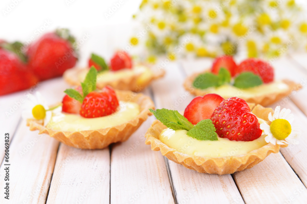 Tasty tartlets with strawberries on table close-up