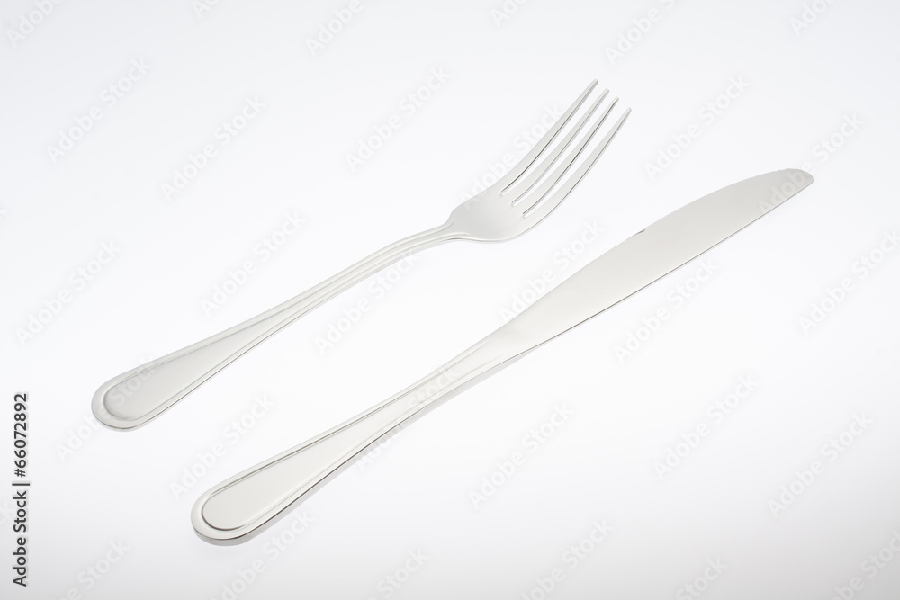 a silver fork with knife isolated on white background a silver fork with knife isolated on white background